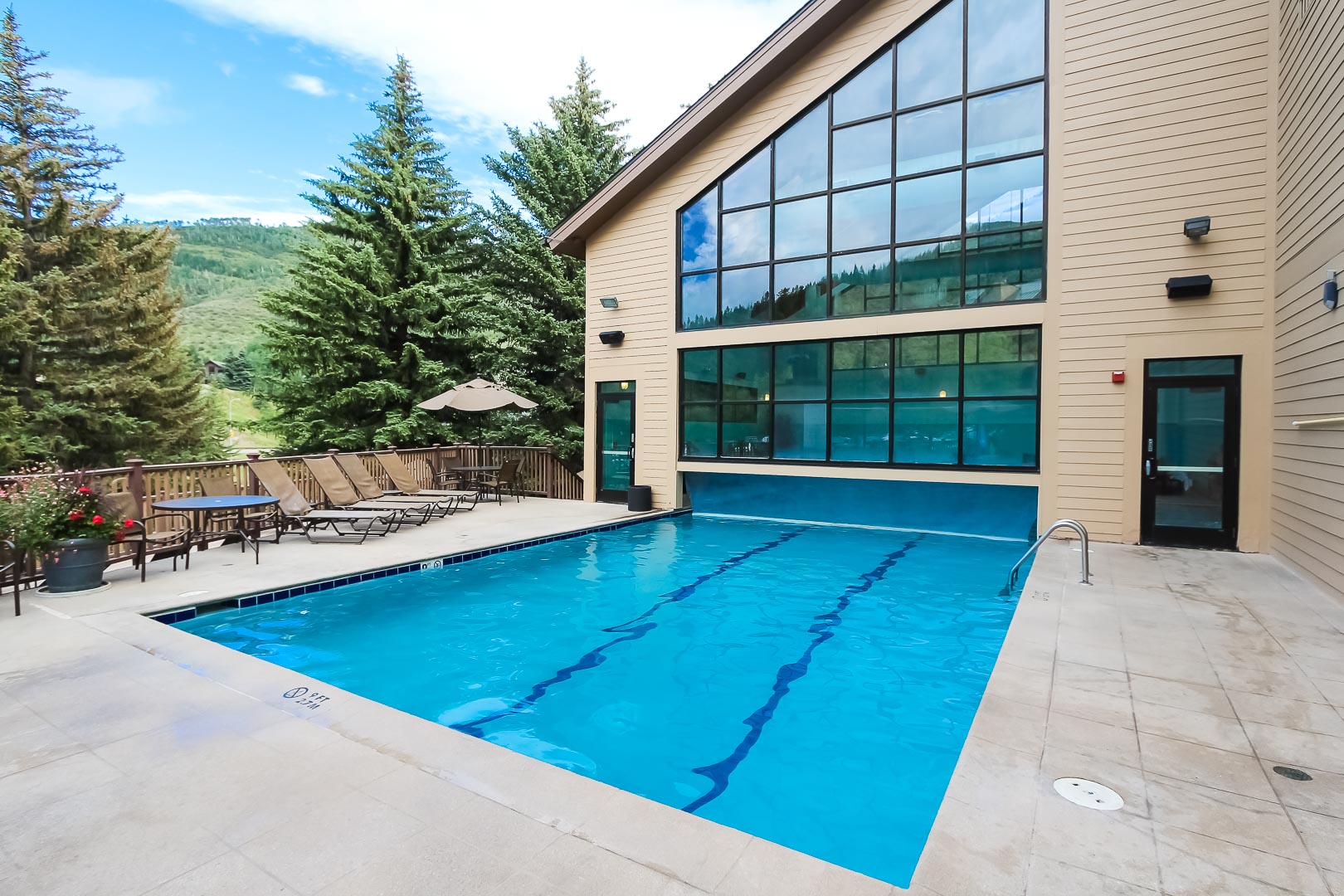 A peaceful outdoor swimming pool with a view at VRI's Cedar at Streamside in Colorado.